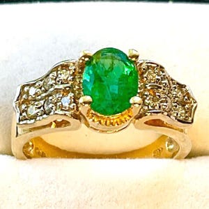 Emerald ring set in 14kt. yellow gold with Diamond accents.  Genuine, size 7