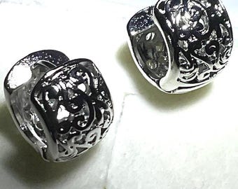 Stainless Steel Huggies earrings.  3/8" wide, covering earlobe with a 1/8" drop.  Floral design.