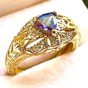 Tanzanite band set in 14kt. yellow gold.  Tanzanite trillion set in gold filigree setting with Diamond accents.  Size 7
