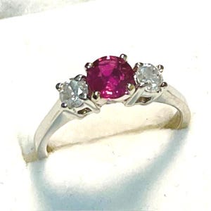 14kt. Gold, Natural Ruby and Diamond Ring. 66 point Ruby, 5mm. Round in 14kt. White Gold with SI Diamond Accents.