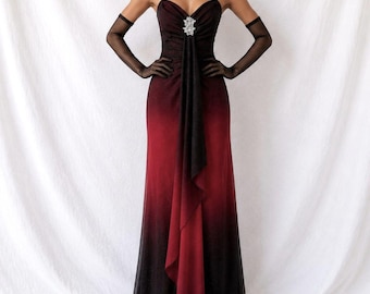 May include: A floor-length gown featuring a black to deep red ombre gradient, thin spaghetti straps, and a central vertical drape detail. The bodice is accented with a silver-toned crystal embellishment at the neckline, paired with sheer black opera-length gloves.