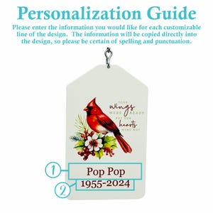 May include: A white ornament with a red cardinal bird illustration, text that reads "Your wings were ready but our hearts were not", and the names "Pop Pop" and "1955-2024". The ornament has a silver metal loop for hanging.