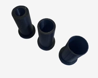 May include: Three black cylindrical objects with a flared base are arranged on a white surface. The cylinders have a hollow interior and a textured appearance. The objects are evenly spaced and angled.