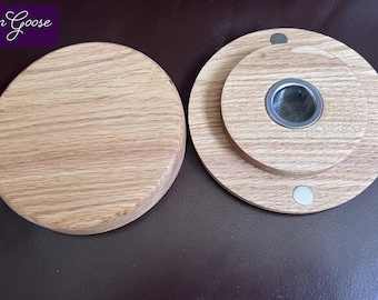 May include: Two circular light-colored wooden discs with a natural grain pattern. One disc is solid, while the other features a central circular metal mesh insert and two small embedded circular magnets. The text Iron Goose appears in the corner.