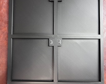 May include: A square black plastic tray featuring four equal compartments arranged in a grid. Each compartment is labeled with a small raised white number in the corner, specifically 1, 2, 3, and 4, indicating the distinct sections for organization.