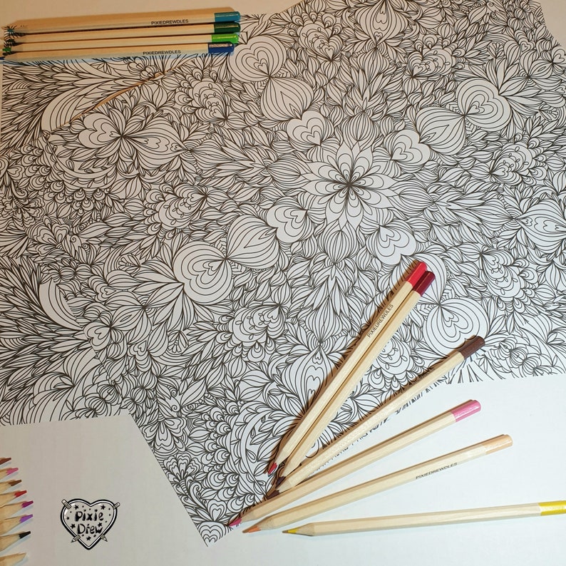 May include: A black and white intricate coloring page with a floral design.  The page is surrounded by wooden colored pencils, some with red, brown, and pink tips.