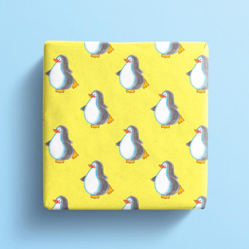 Pu&ograve; includere: Carta da regalo gialla con un motivo ripetitivo di pinguini. I pinguini sono neri e bianchi con becchi e piedi arancioni.