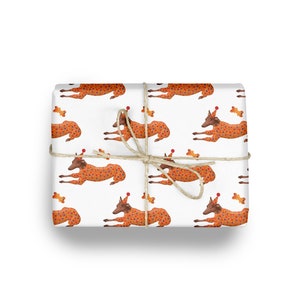 May include: White wrapping paper with a repeating pattern of brown dogs wearing orange and red polka dot pajamas and party hats. Each dog is holding a bone.