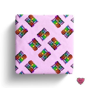 May include: Pink wrapping paper with a repeating pattern of the phrase "Grumpy Bastard" in rainbow colors.
