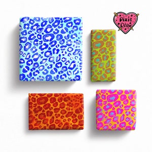 May include: Four gift boxes featuring various leopard print designs. The boxes are wrapped in blue, orange, green, and pink leopard print paper. All boxes are the same size and shape.