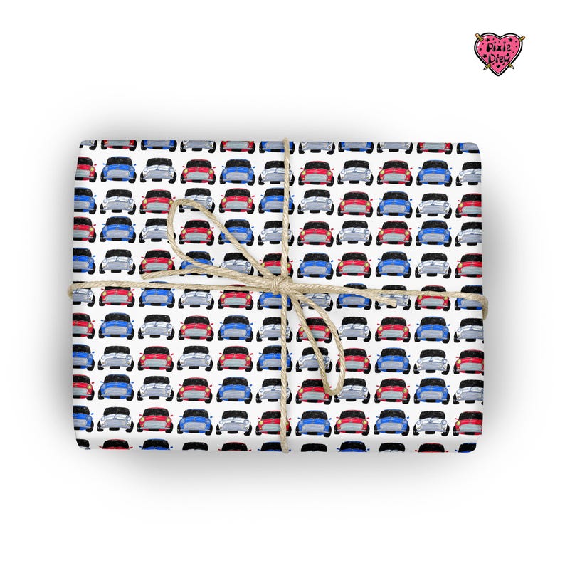 May include: White wrapping paper with a repeating pattern of red, blue and silver miniature cars. The paper is tied with a brown twine bow.