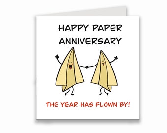 May include: A white card with the text "Happy Paper Anniversary" and two cartoon paper airplanes holding hands. The text "The year has flown by!" is written below the airplanes.