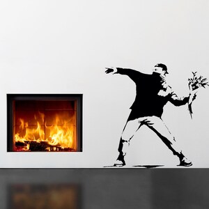 May include: Black and white silhouette of a person throwing a bouquet of flowers. The person is wearing a mask and is in a running pose. The image is a wall decal.