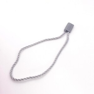 May include: A silver-coloured string loop with a plastic tag at the end. The loop is twisted and has a shiny finish.