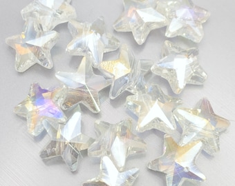May include: A collection of clear, faceted star-shaped beads. The beads have an iridescent quality, reflecting multiple colors. These decorative beads are ideal for crafting and jewelry making.