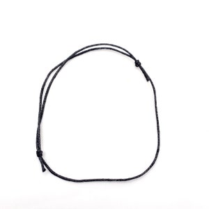 May include: A black cord necklace with a simple knot closure.