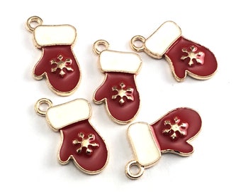 May include: Five gold-tone metal charms shaped like red and white mittens with a gold snowflake design.