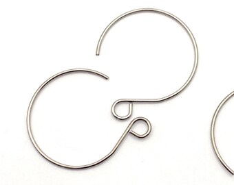 May include: Two silver hoop earrings with a small loop at the top for attaching to a hook.