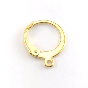 May include: Gold-toned earring hook with a small loop at the bottom. The hook is made of metal and has a smooth finish.