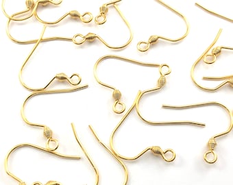 May include: A group of gold-toned earring hooks with a wire loop at the top and a small, coiled wire detail at the bottom.