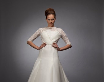 Anne: Lace and gazar gown; jewel collar, half-sleeve top in corded French lace with asymmetrical gazar draping over modified a-line skirt.