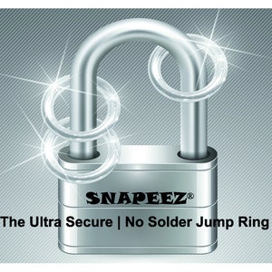 May include: A silver padlock with two silver jump rings around the shackle. The padlock has the text "SNAPEEZ&reg;" and "The Ultra Secure | No Solder Jump Ring" on the body.