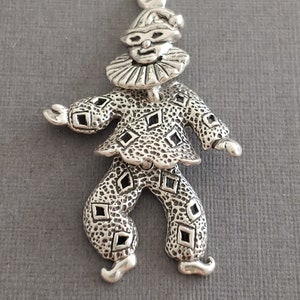 Limited edition sterling silver 3 piece movable Harlequin clown charm measuring 21x32mm. Weight of charm is 3.1 grams.  Made in USA.