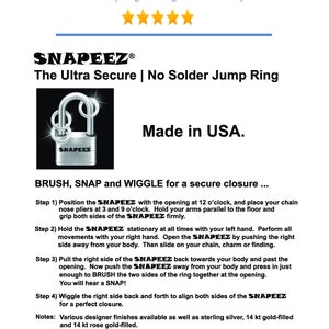 May include: A silver jump ring with the words "SNAPEEZ" engraved on it. The ring is closed and has a secure closure. The image includes instructions on how to use the ring, which are "BRUSH, SNAP and WIGGLE for a secure closure..." The image also includes the text "Made in USA."