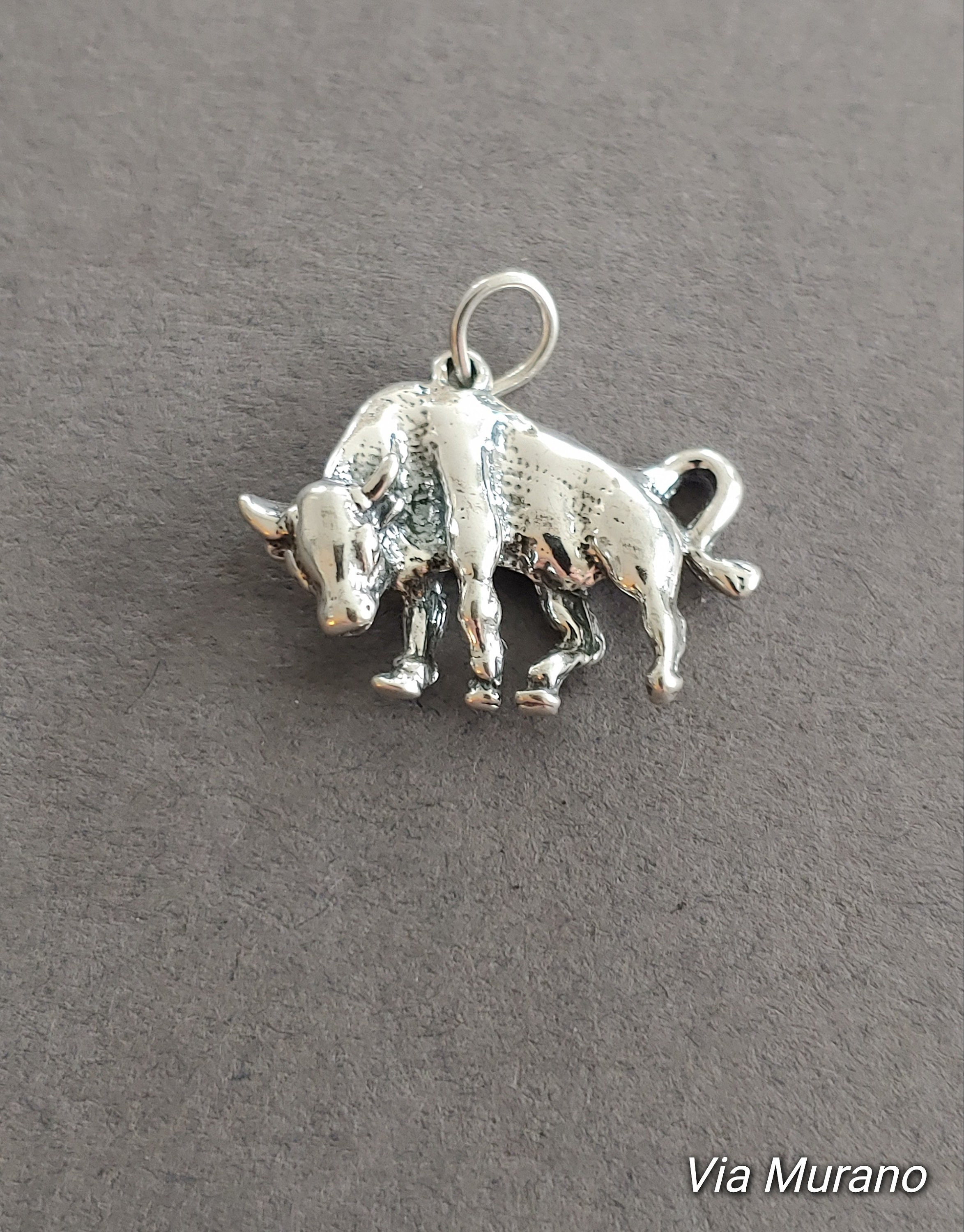 Limited edition sterling silver bull charm measuring 25x16mm. Weight of charm is 5.0 grams.  Made in USA.