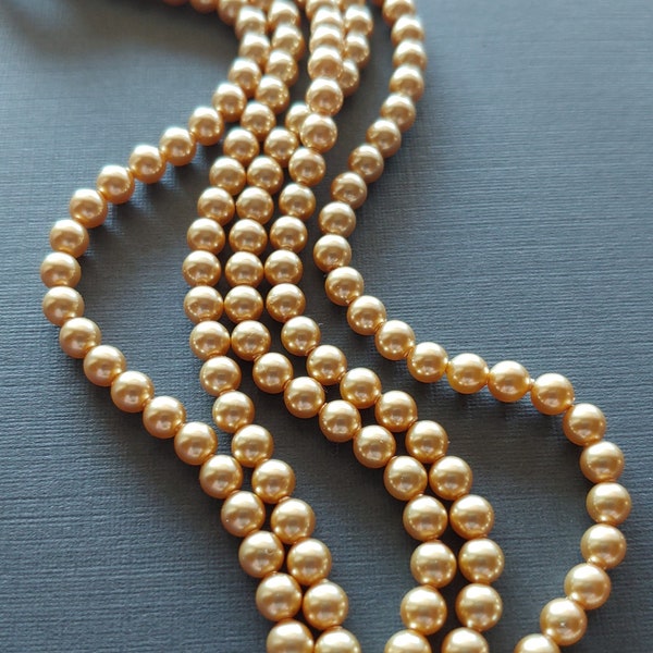 Swarovski 5810 Crystal 4mm Round Gold Pearl Beads for Jewelry Stringing and Knotting Jewelry.  Sold per strand of 100 beads per strand.