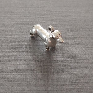 Limited edition sterling silver dachshund dog charm measuring 20mm x 13mm. Weight of charm is 3.37 grams.  Made in USA.