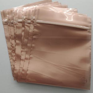 May include: A white ceramic mug with a black handle and the text "But First, Coffee" in a handwritten style. The mug is on a white surface. The mug is approximately 4 inches tall.