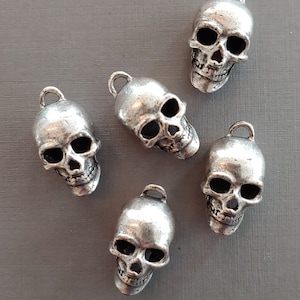 White Silver Skull Charm Measuring 27x15mm (Pk 5). Made in USA.