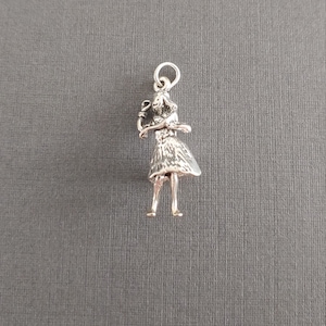 Limited edition sterling silver Hawaiian hula girl dancer charm measuring 25mmx10mm. Weight of charm is 4.43 grams. Made in USA.