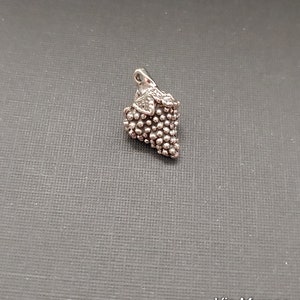 Limited edition sterling silver grape cluster charm measuring 12mmx19mm. Weight of charm is 3.75 grams.  Made in USA.