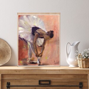 May include: A painting of a ballerina in a white tutu tying her ballet shoes. The background is a soft pink and orange.