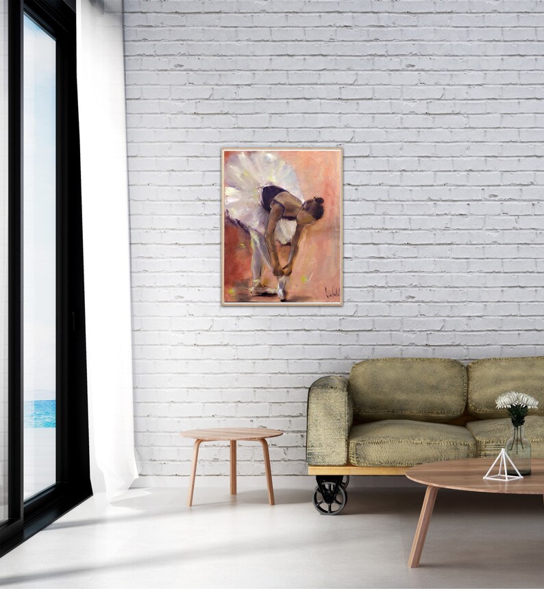 May include: A painting of a ballerina in a white tutu, tying her shoe. The background is a soft pink and orange.