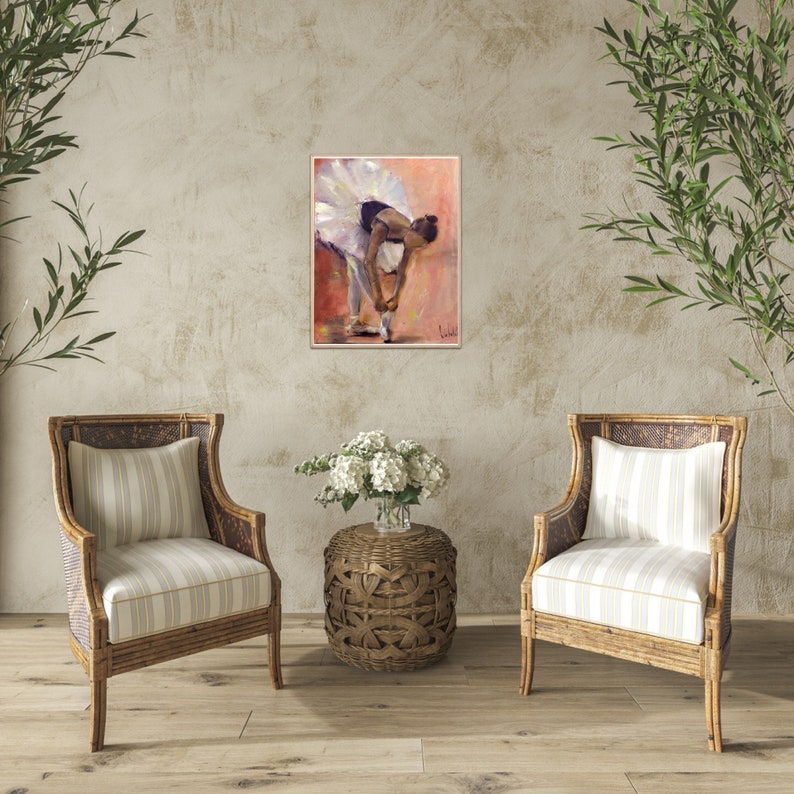 May include: A painting of a ballerina in a white tutu, tying her shoe. The background is a soft pink and orange.