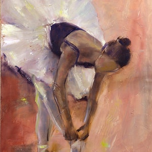 May include: A ballerina in a white tutu and black leotard is tying her pointe shoes. The background is a soft peach color with hints of yellow.