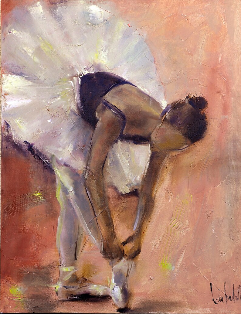 May include: A ballerina in a white tutu and black leotard is tying her pointe shoes. The background is a soft peach color with hints of yellow.