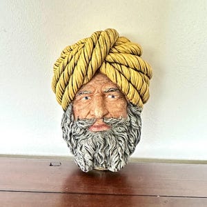 May include: A white ceramic mug with a black handle and the text "But First, Coffee" in a black, bold font. The mug is sitting on a white surface. The mug appears to be 12 ounces.