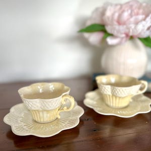 May include: A set of three ceramic mugs with a speckled, matte finish. The mugs are in shades of cream, light grey, and dark grey. Each mug has a simple, minimalist design, ideal for coffee or tea.