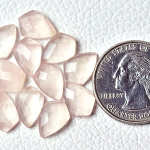 May include: Ten faceted rose quartz stones, each about the size of a US quarter, arranged in a circle on a white surface.