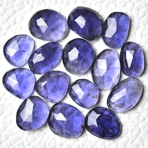 Peut inclure: Une collection de 14 pierres précieuses d'améthyste violettes facettées. Les pierres sont de forme ovale et ont une finition lisse et polie.