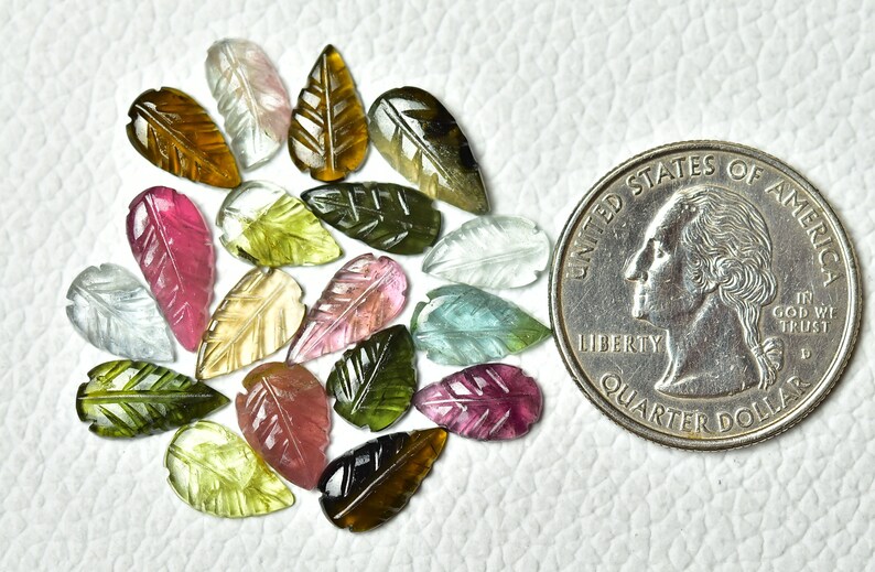 May include: Assortment of 20 carved gemstone leaf beads in various colors, including green, pink, brown, and blue. The beads are approximately the size of a US quarter.
