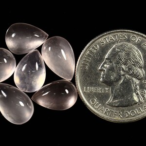 May include: Six teardrop-shaped, translucent pink rose quartz cabochons, each about the size of a US quarter.