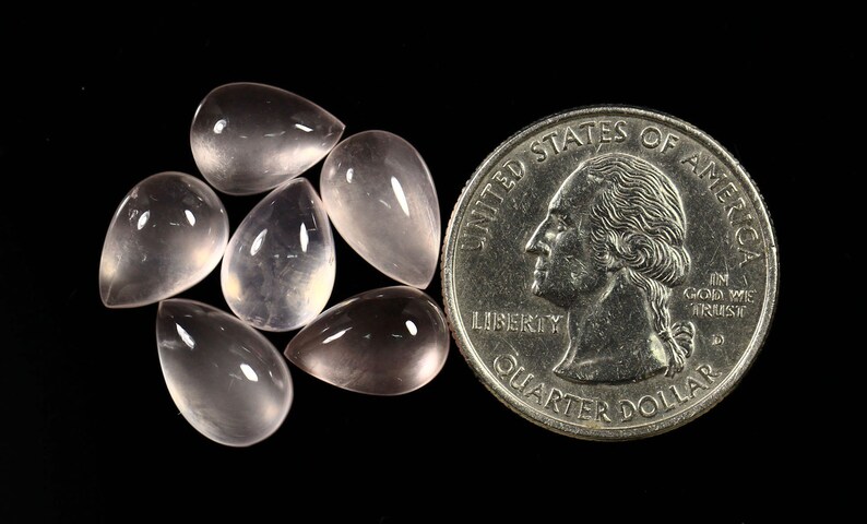 May include: Six teardrop-shaped, translucent pink rose quartz cabochons, each about the size of a US quarter.