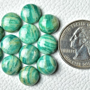 May include: A collection of 14 green and white amazonite cabochons, each approximately the size of a UK 20 pence coin.