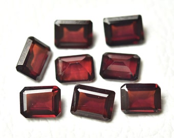 May include: Eight red gemstone rectangular cut loose stones. The stones are faceted and have a deep red color.