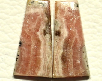 May include: Pair of pink and white striped cabochon gemstones with black and brown inclusions.